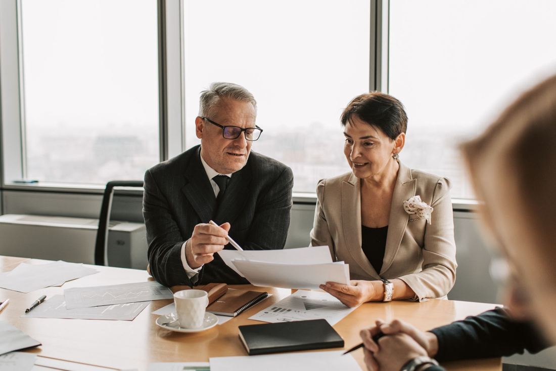 Two board members reviewing a paper together
